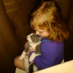 Riley giving Pudding a kiss between the shower curtains.