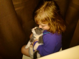 Riley giving Pudding a kiss between the shower curtains.